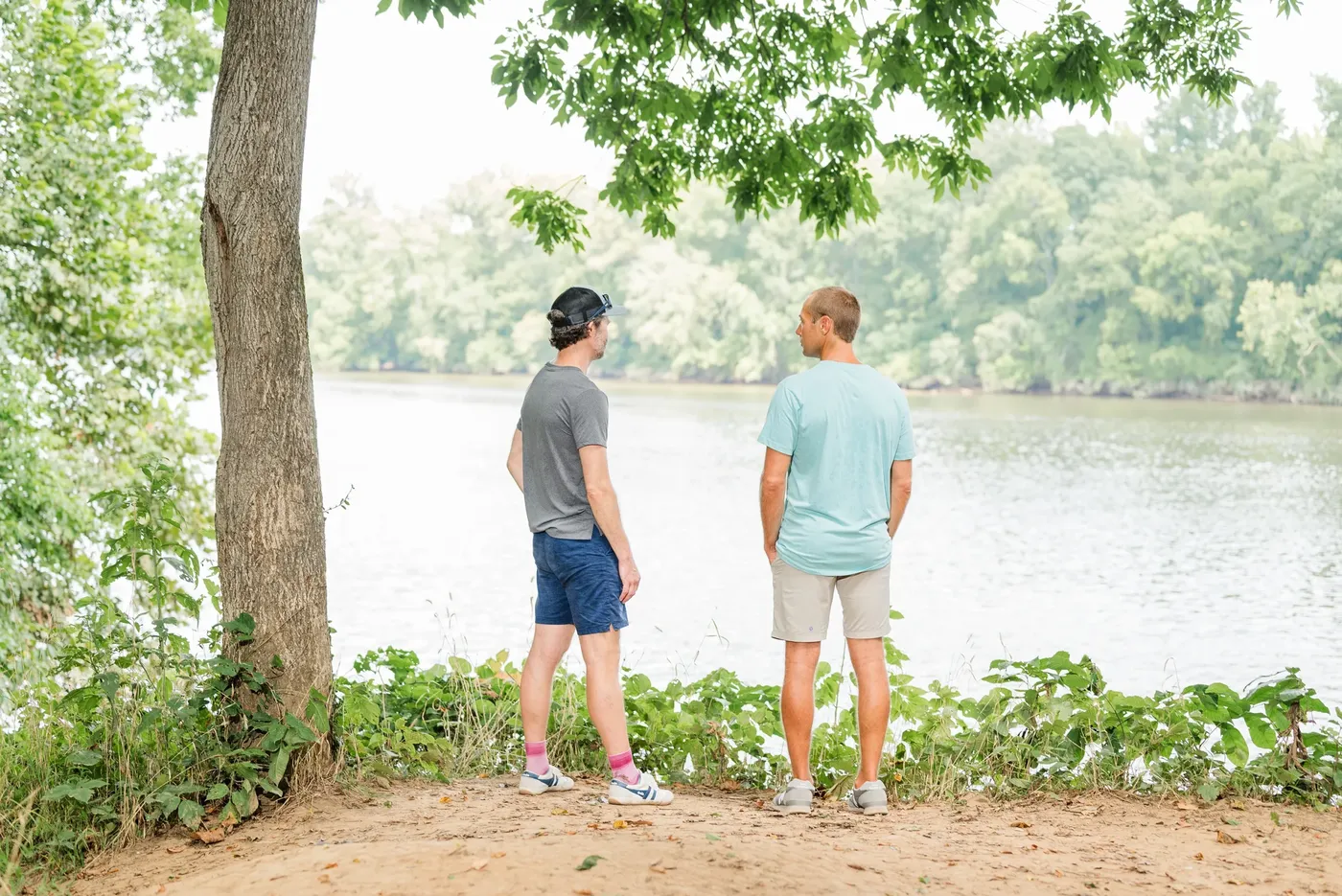 Two men talking at the bank of the James River