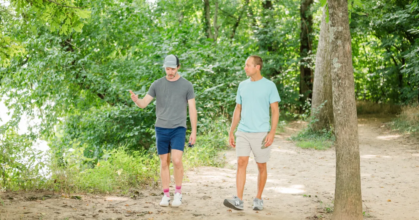Therapist and client in conversation while walking a wooded James River trail